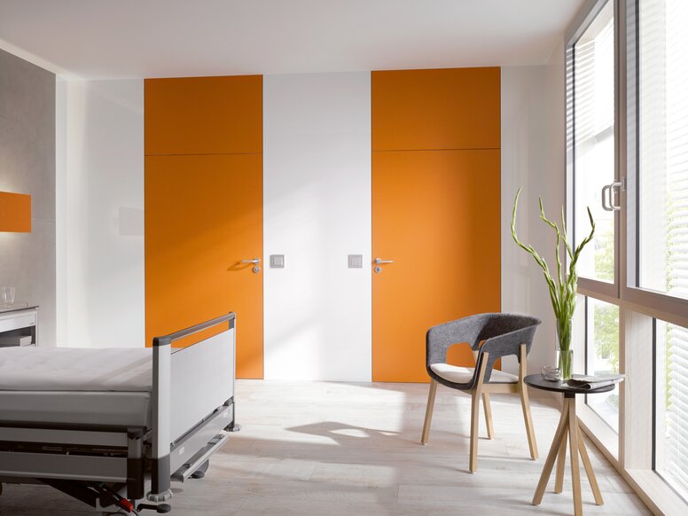 HEWI lever handle 111 White hospital room with two orange doors fitted with a lever handle in the colour grey made of polyamide
